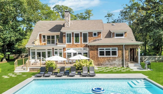 Modern Coastal Farmhouse style home with a private pool, open-floor plan,.